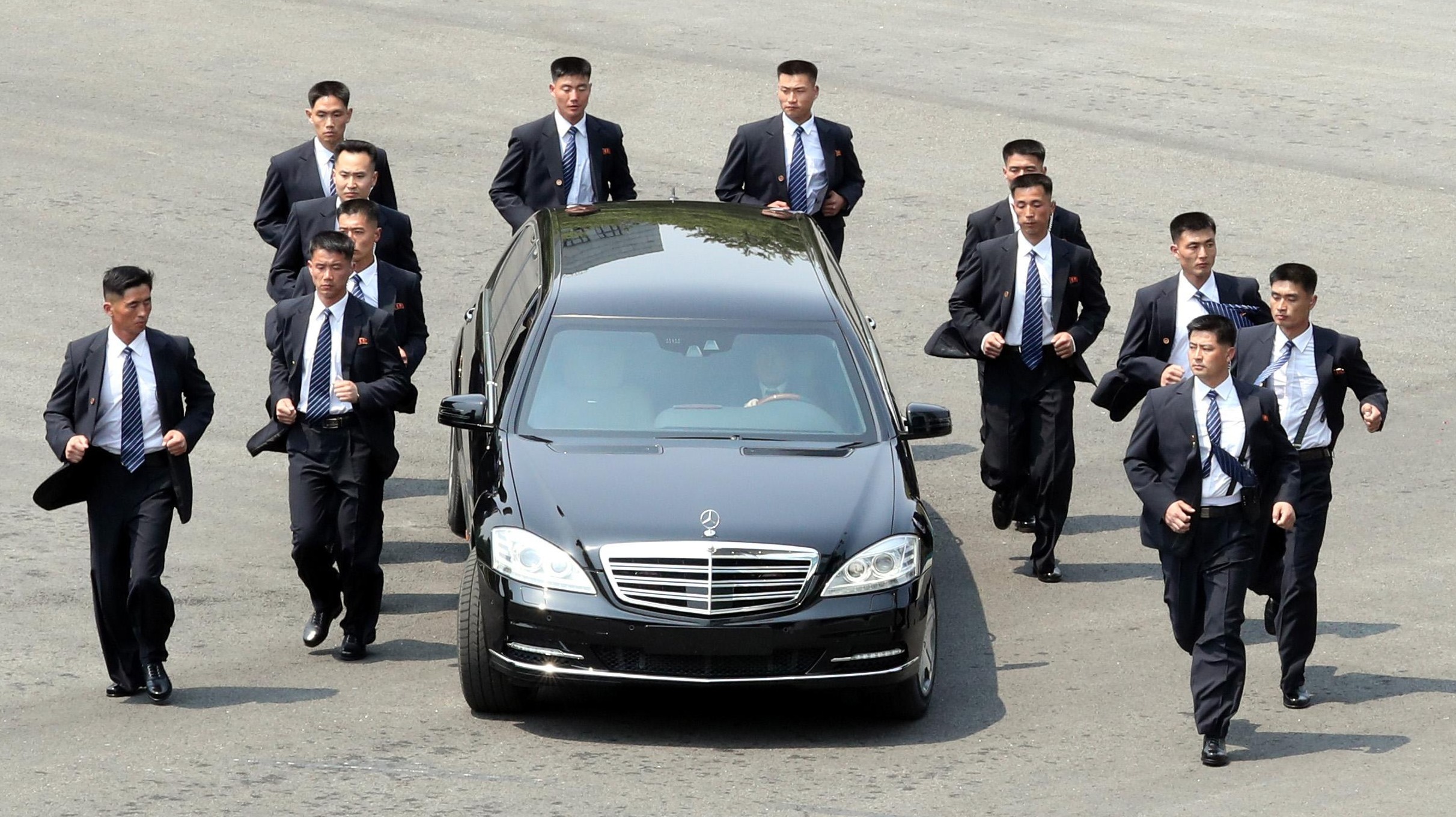 Kim is surrounded by a dozen security guards during talks in 2018 with South Korea