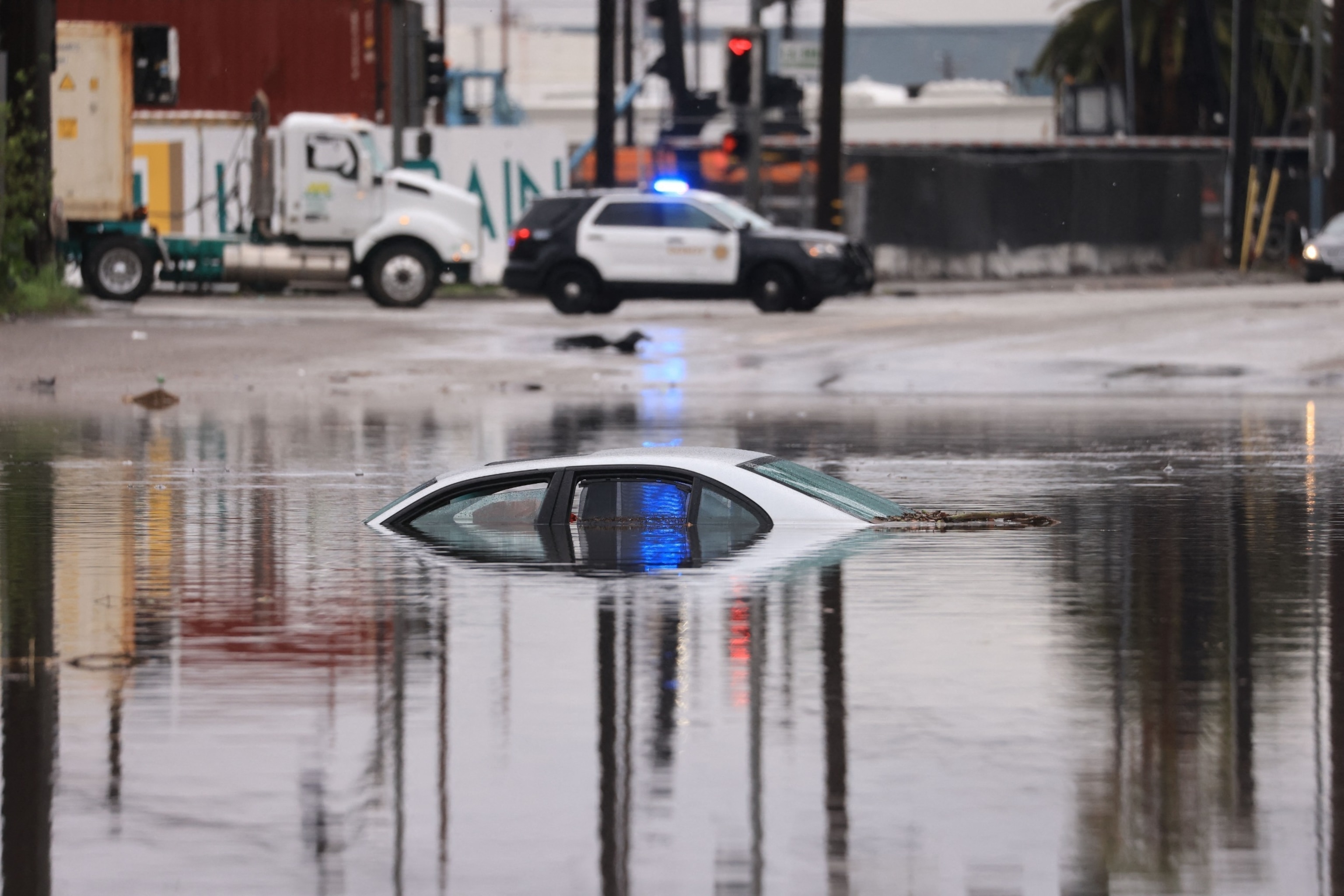 PHOTO: A car sits partially submerged on a flooded road during a rain storm in Long Beach, Calif., on Feb. 1, 2024.