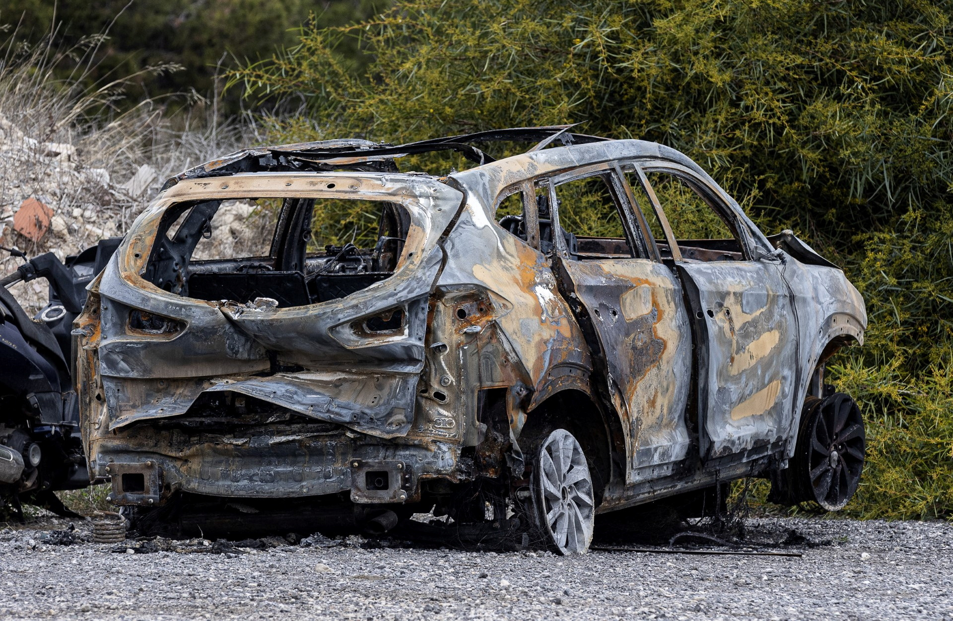 The car his killers allegedly used to flee before setting on fire