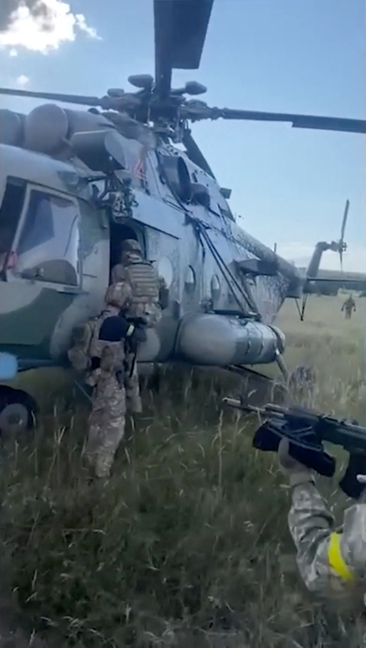 Ukraine intelligence officers inspect the Russian chopper which they say was stolen by Maxim Kuzminov