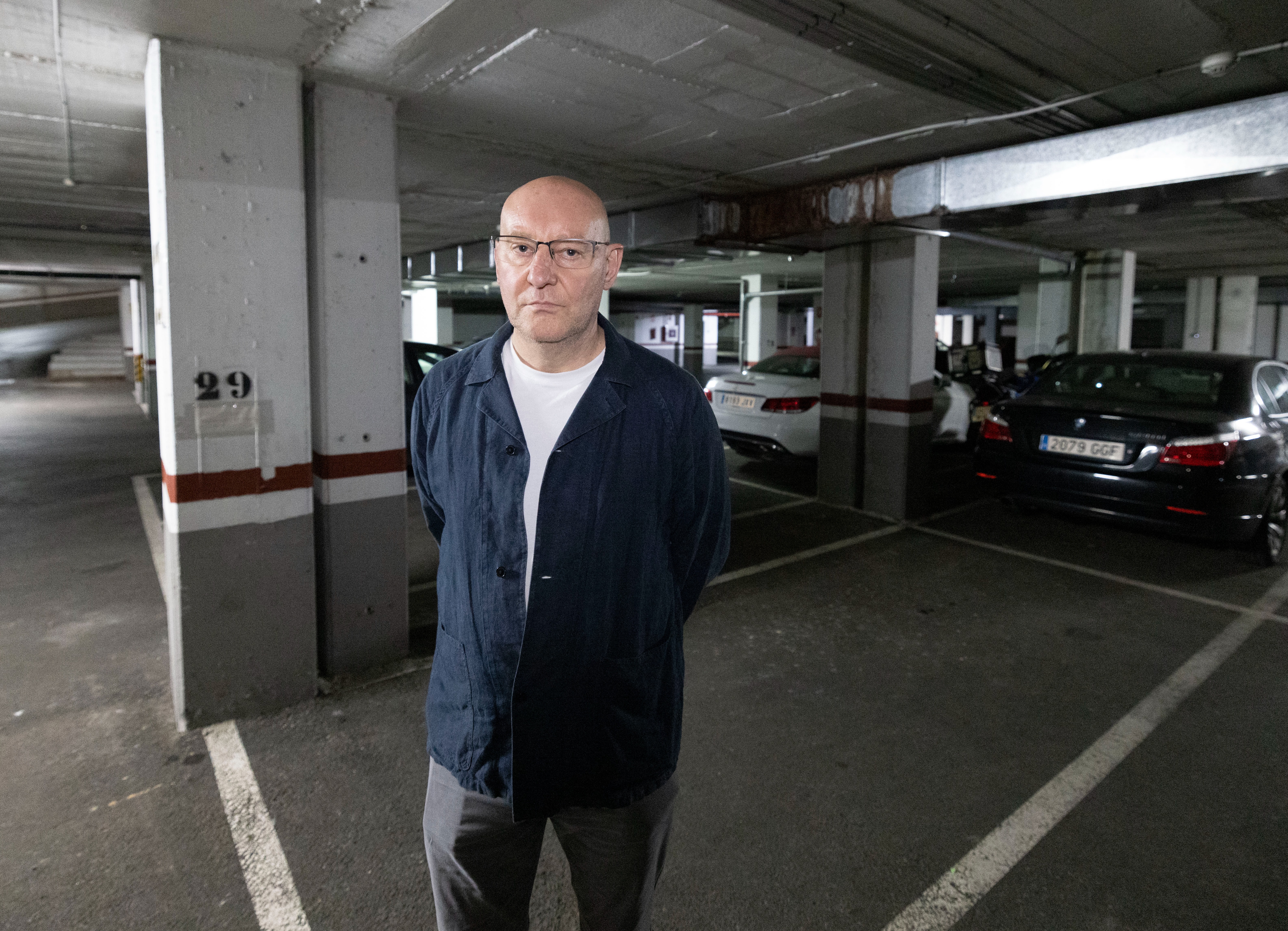 The Sun's Nick Parker stands in murdered Russian pilot Captain Maxim Kuzminov's parking space in the underground car park where his body was found