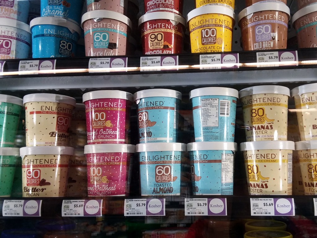 Shelf displaying containers of Enlightened low calorie ice cream at a Whole Foods store in Nashville, TN, USA on April 6th, 2018
