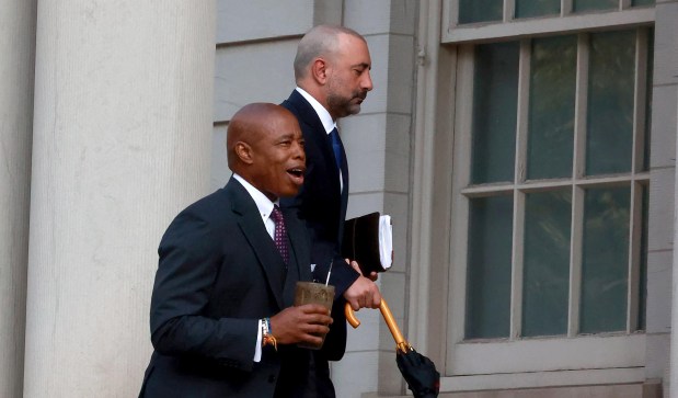 New York City Mayor Eric Adams walk with his Chief of Staff Frank Carone.